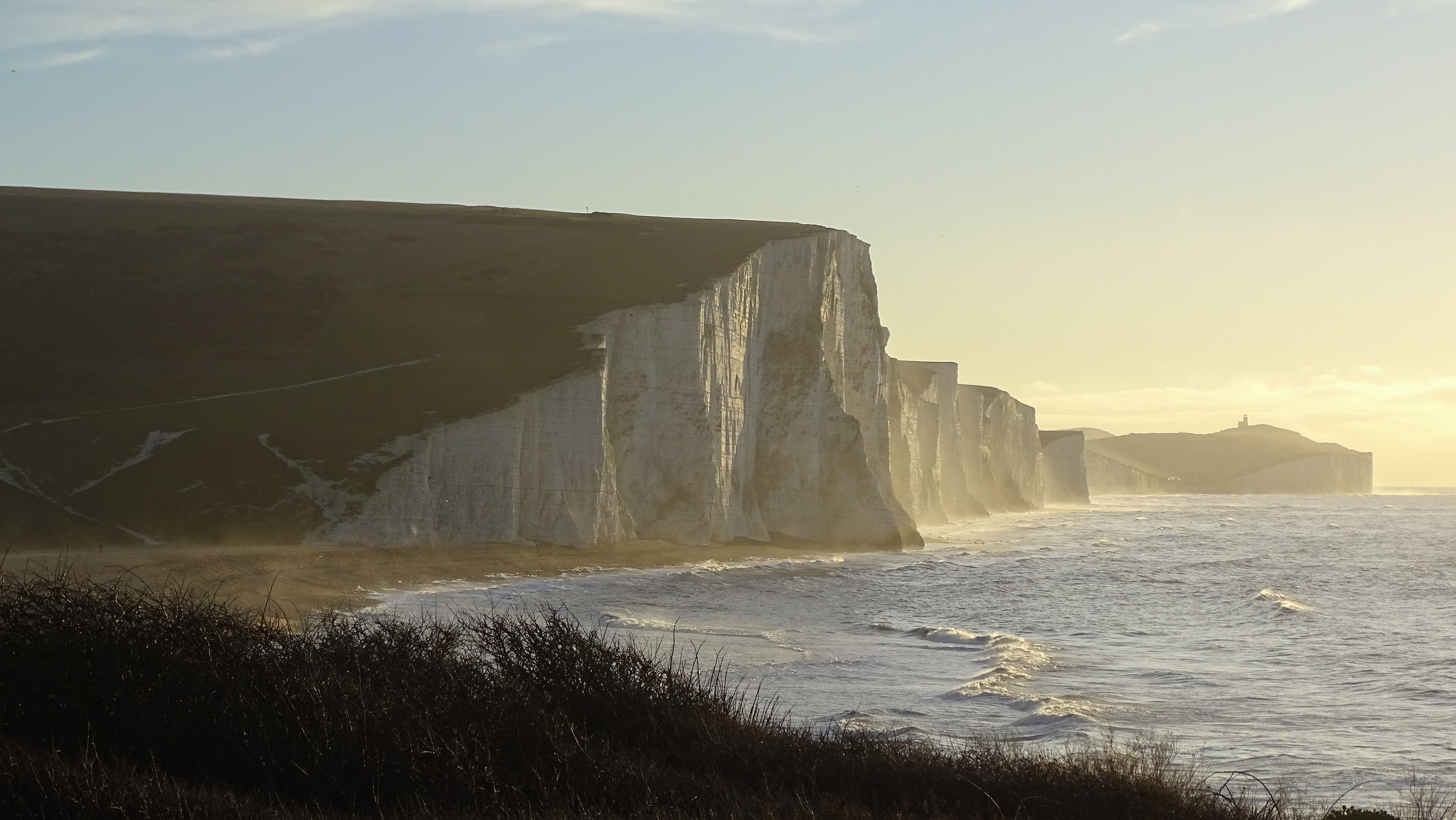 Seven Sisters white cliffs and Beachy Head lighthouse on the Sussex coast in golden light – original photograph by Sharon Maskery