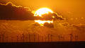 Dramatic golden sunset behind offshore wind turbines on the Sussex coast – original photography by Sharon Maskery