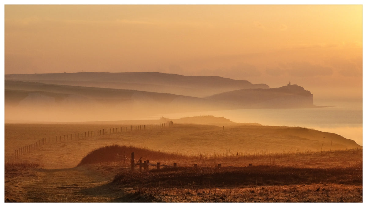 Golden light and sea mist across the rolling Sussex coastline – original landscape photography by Sharon Maskery