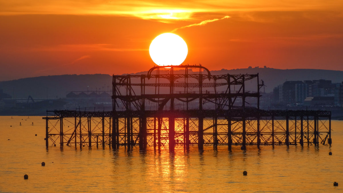 Brighton’s West Pier silhouetted beneath a brilliant golden sunset – original Sussex coastal photography by Sharon Maskery